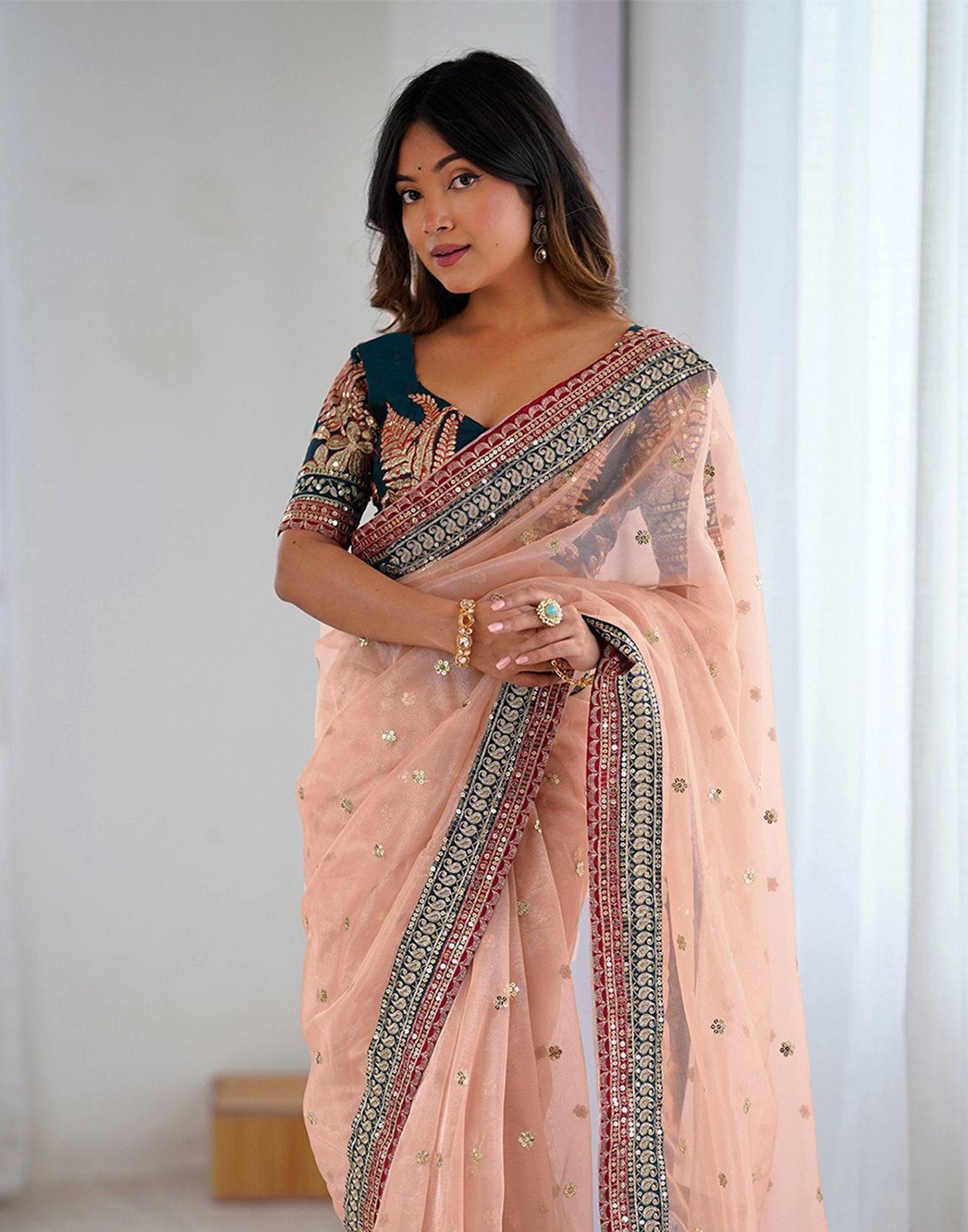 Pastel Peach Party Wear Net Saree with Traditional Embroidered Border