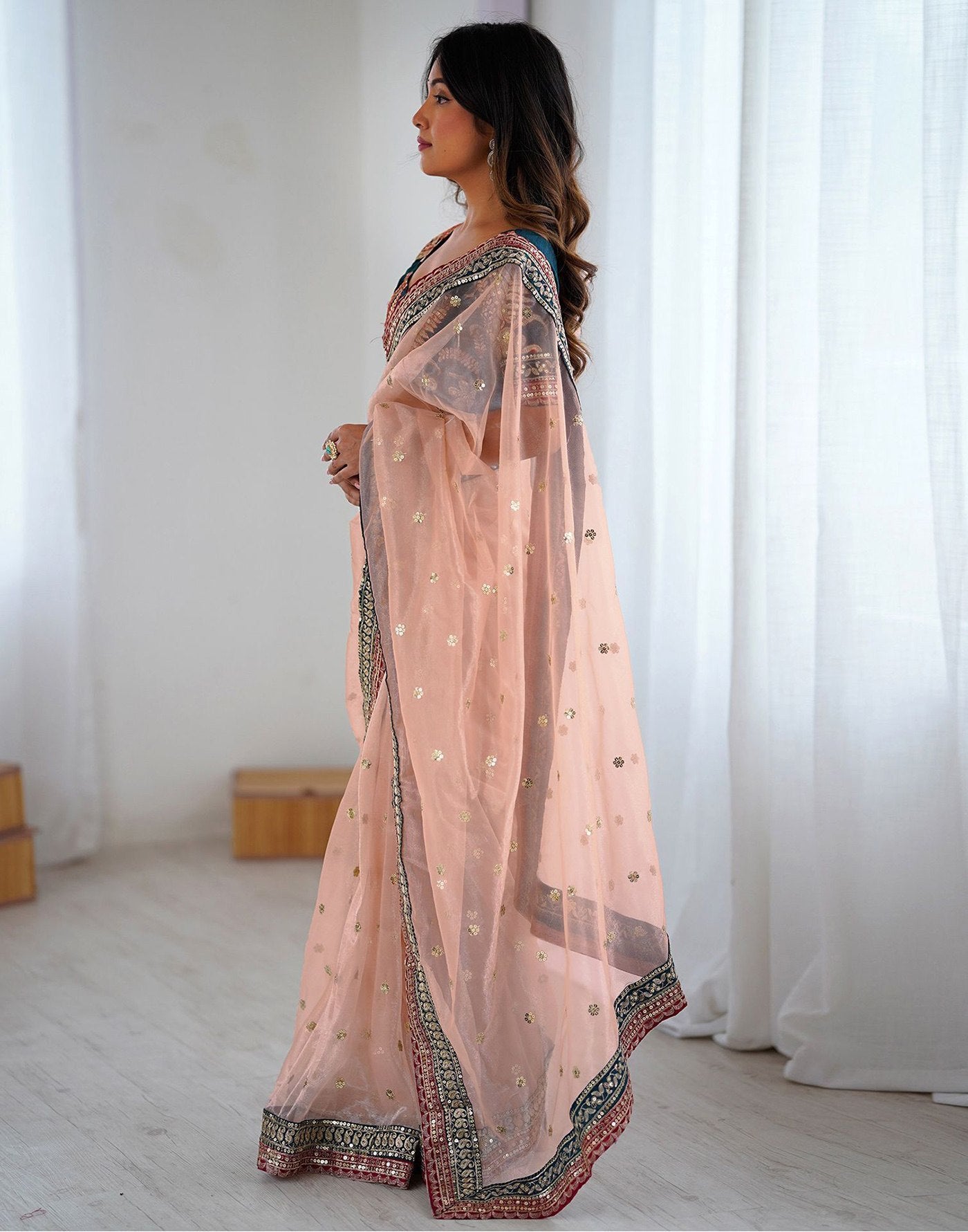Pastel Peach Party Wear Net Saree with Traditional Embroidered Border