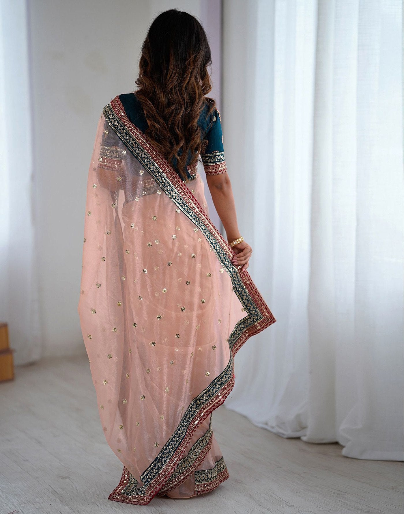 Pastel Peach Party Wear Net Saree with Traditional Embroidered Border