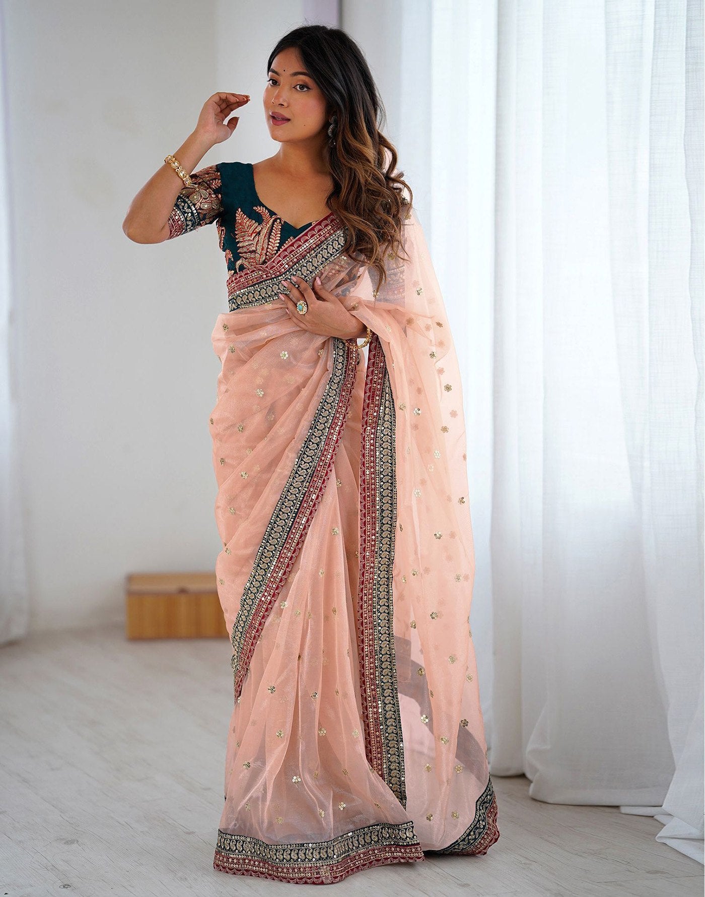 Pastel Peach Party Wear Net Saree with Traditional Embroidered Border
